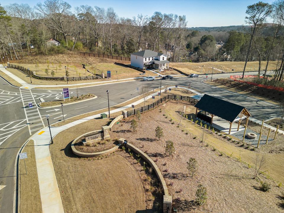 A road with a building and trees on the side.