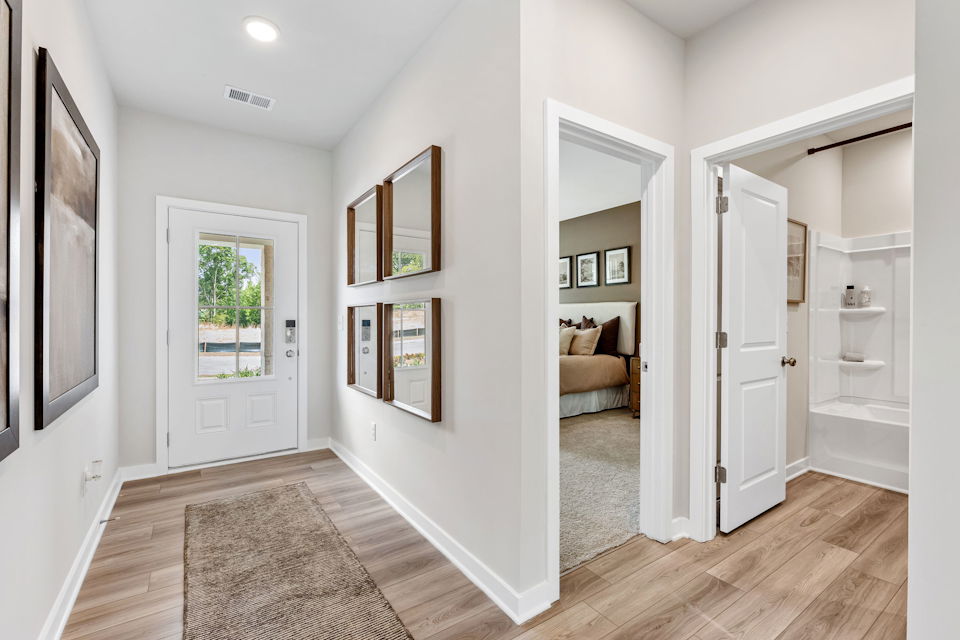 A room with white walls and a wood floor.