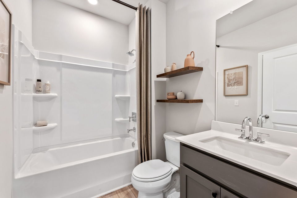 A bathroom with a tub toilet and sink.
