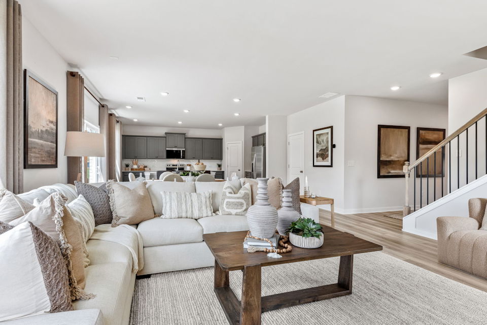 A large living room with a large staircase.