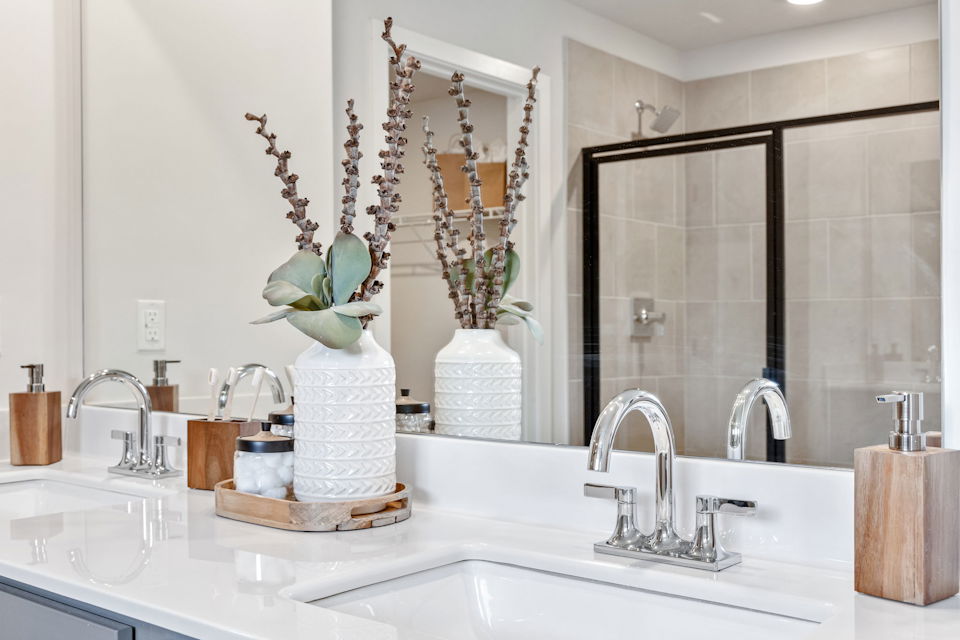 A bathroom with a large mirror.