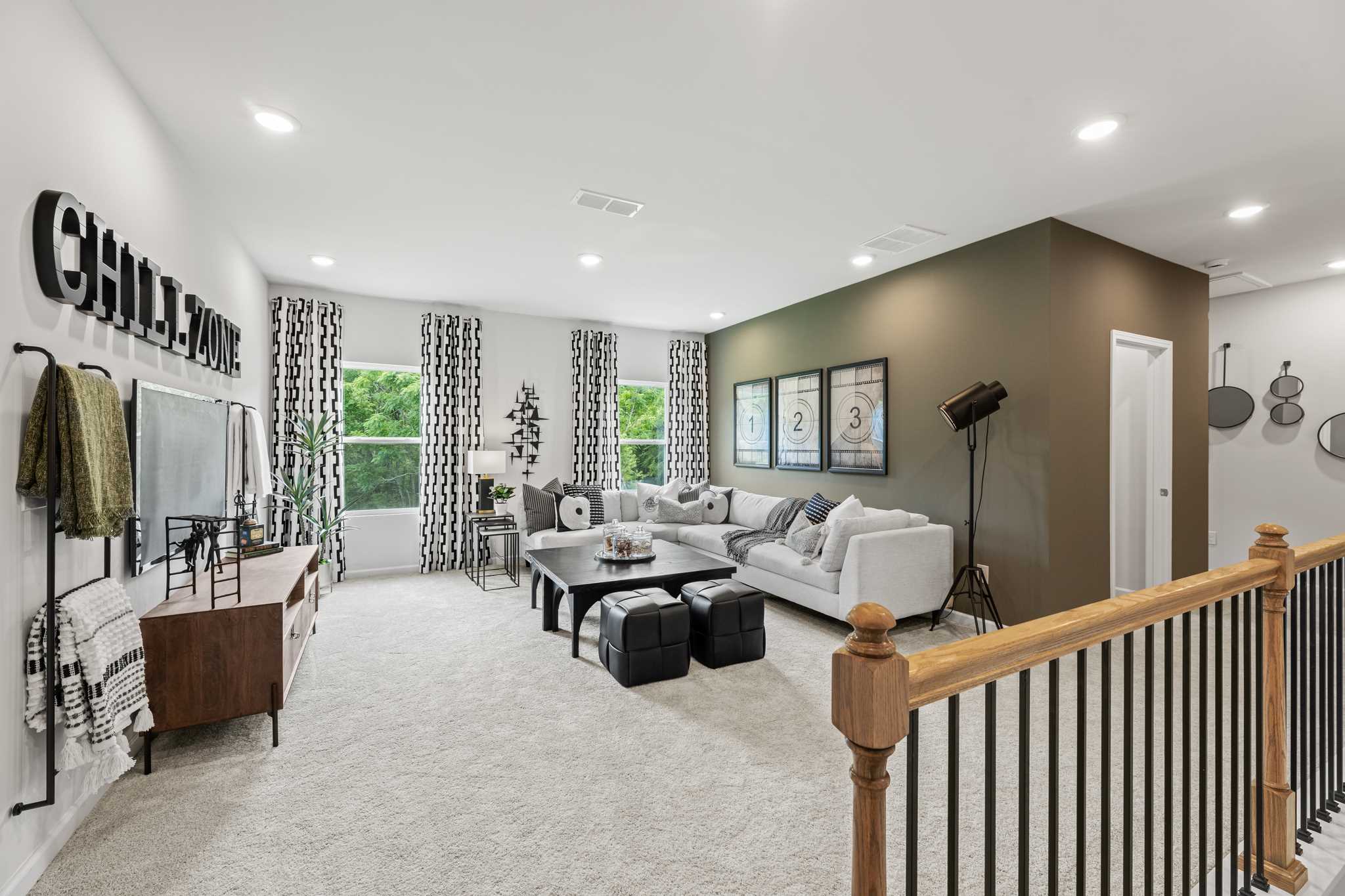 A large living room with a large staircase.