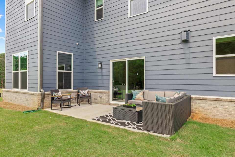A backyard with a bench and a fireplace.