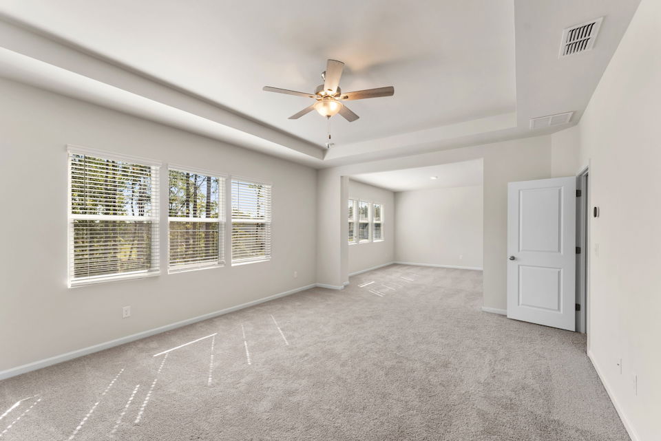 A room with a ceiling fan and a window.