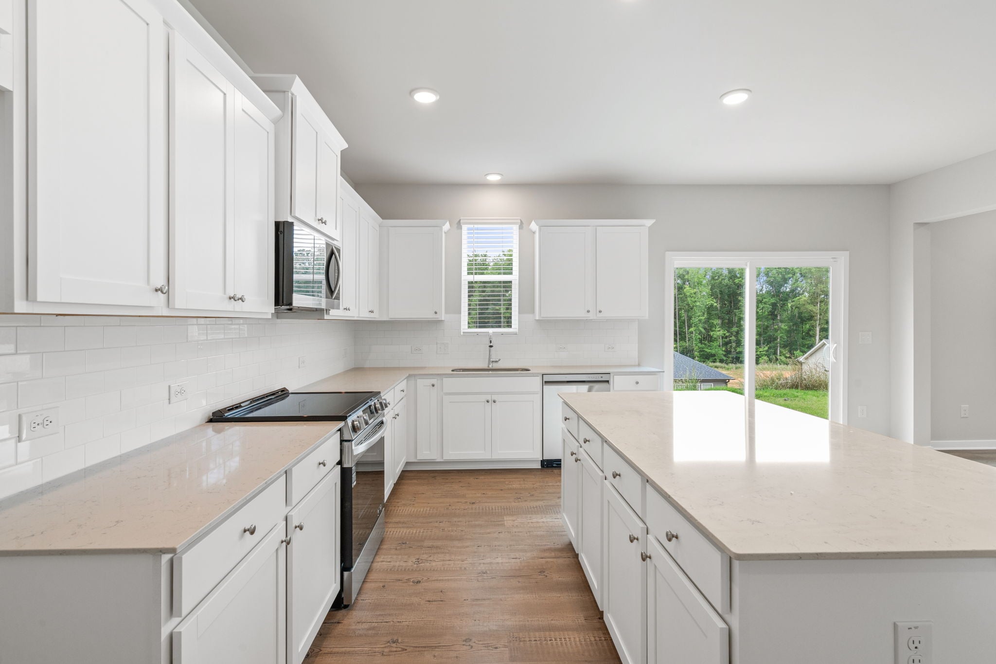 A kitchen with white cabinets.