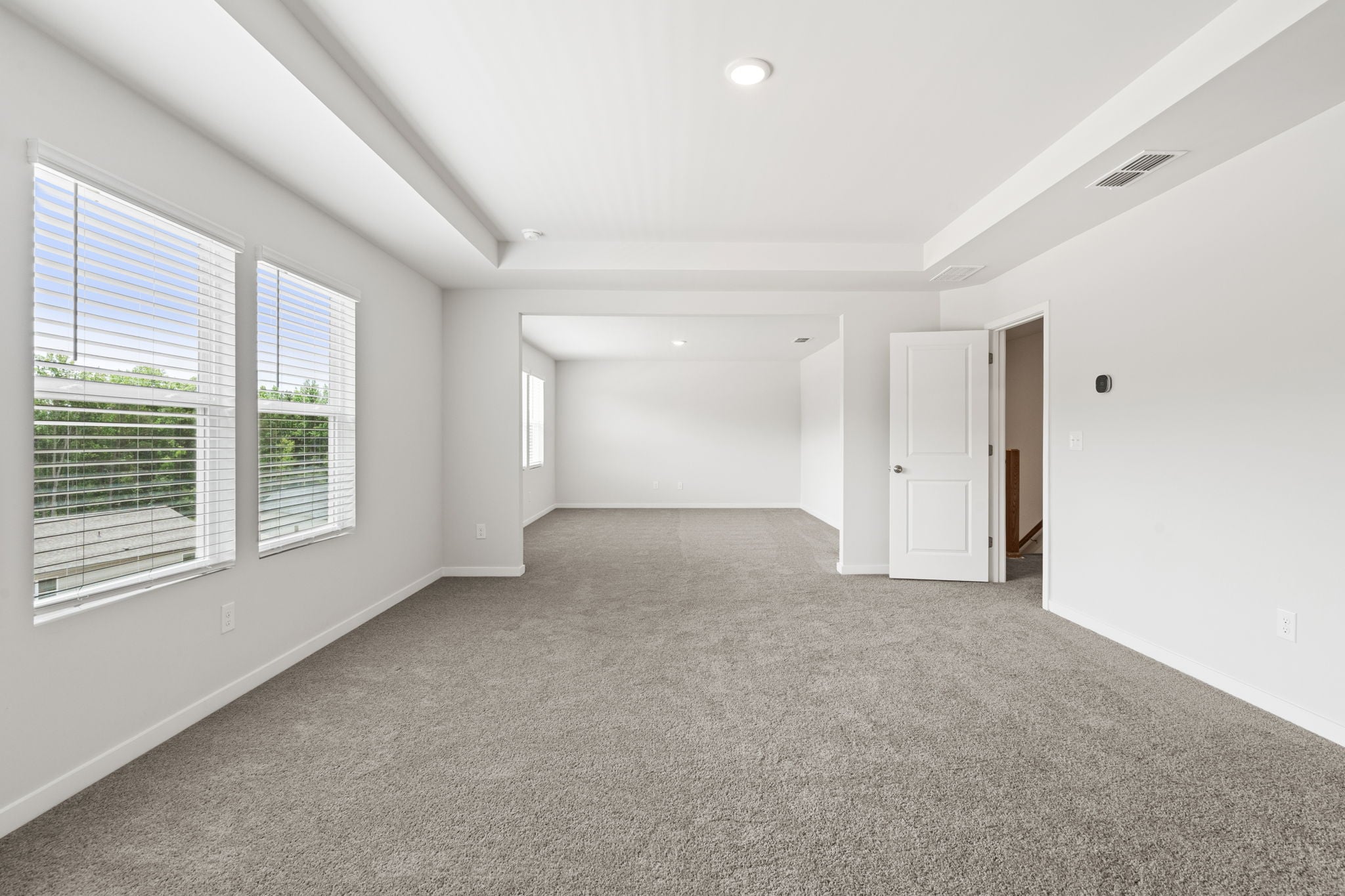 A room with white walls and windows.