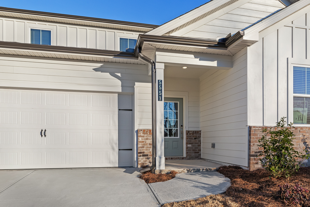A white house with a garage.