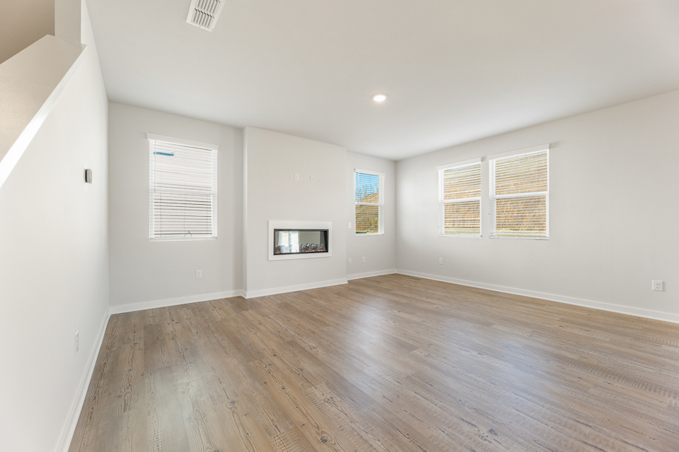A room with a wood floor and white walls.