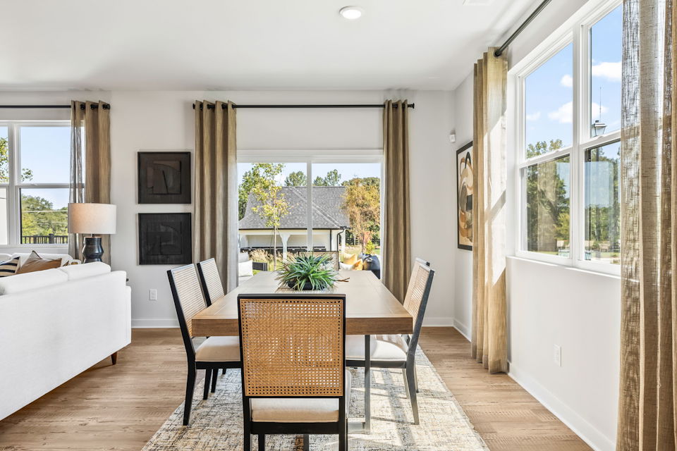 A dining room with a large window.