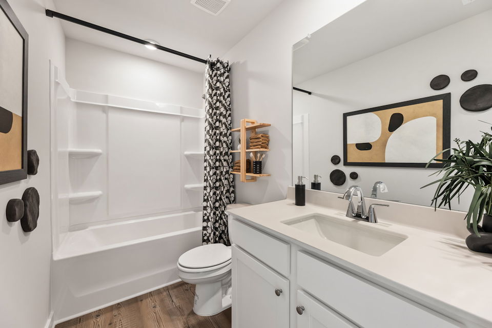 A bathroom with a tub sink and toilet.