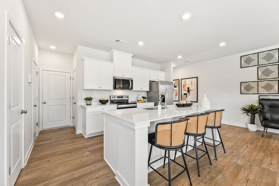 A kitchen with white cabinets.