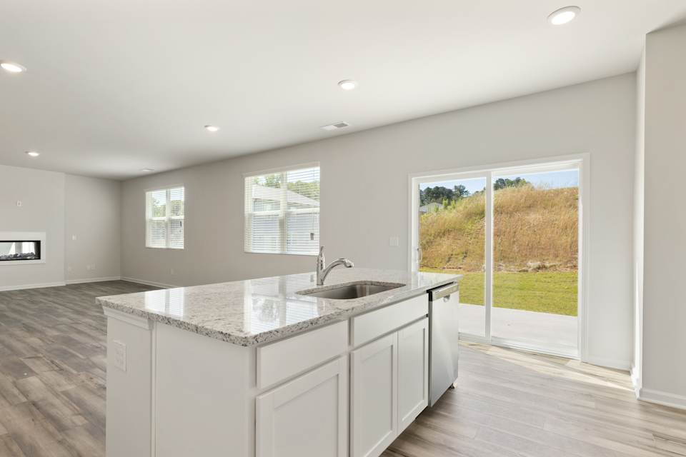 A kitchen with a large window.