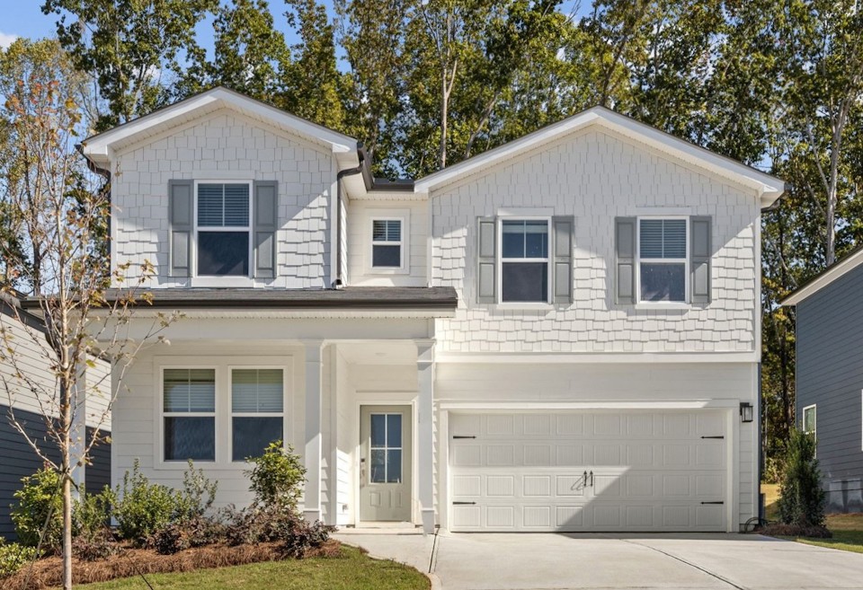 A white house with a garage.