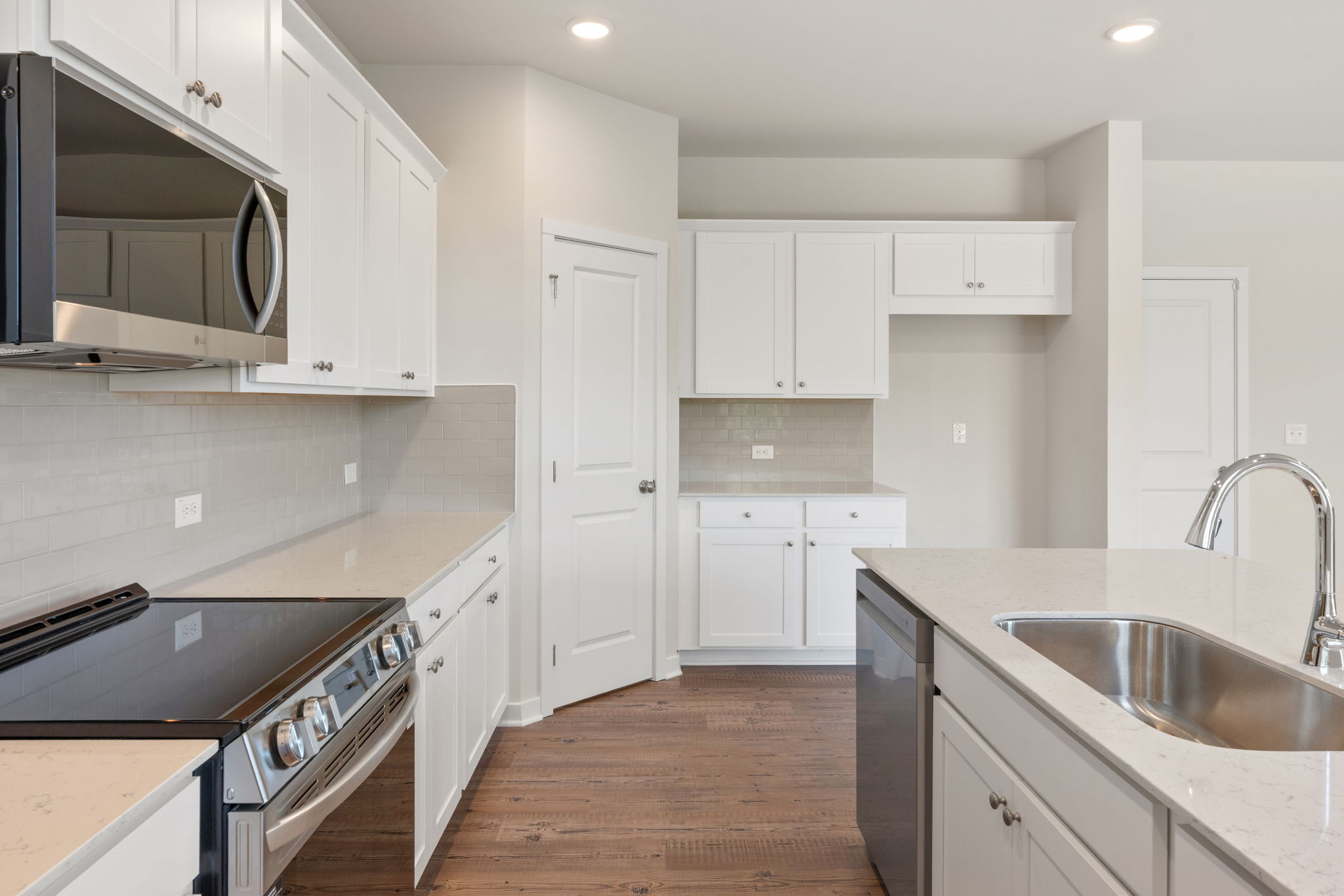 A kitchen with white cabinets.