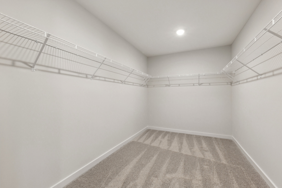 A white hallway with a rug.