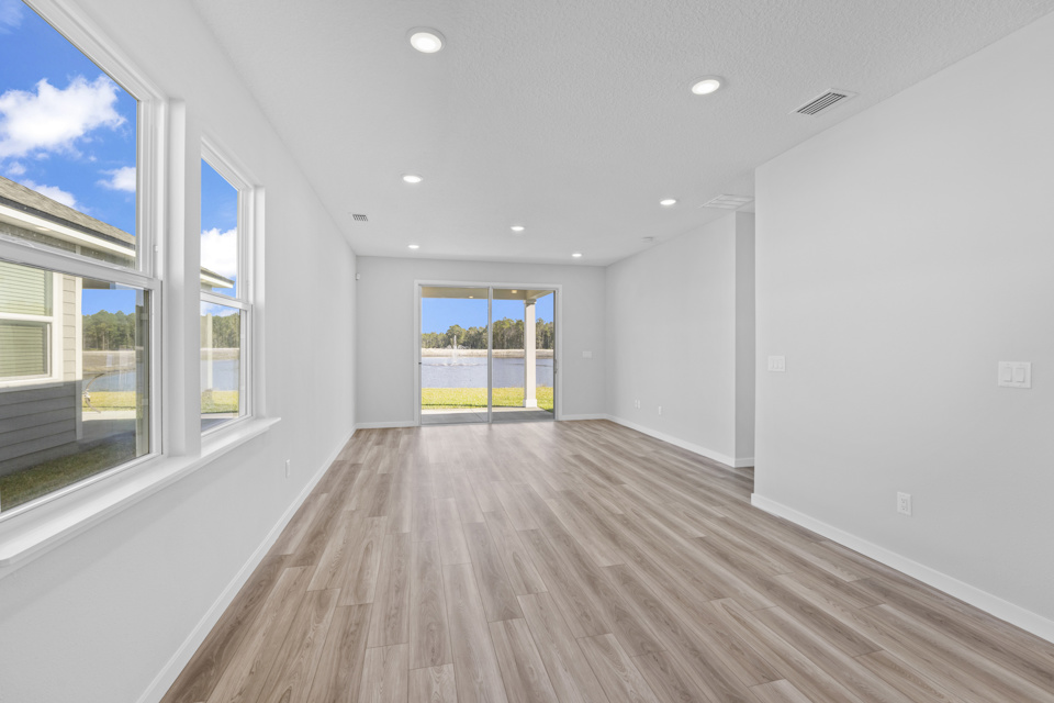 A room with windows and a wood floor.