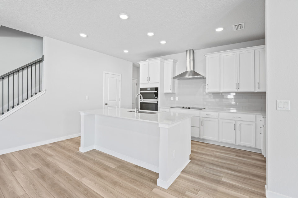 Lot 22 Chef's Kitchen with White Cabinets at Camden Woods in Kingsland