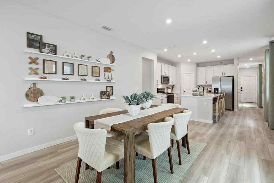 A kitchen with a dining table.