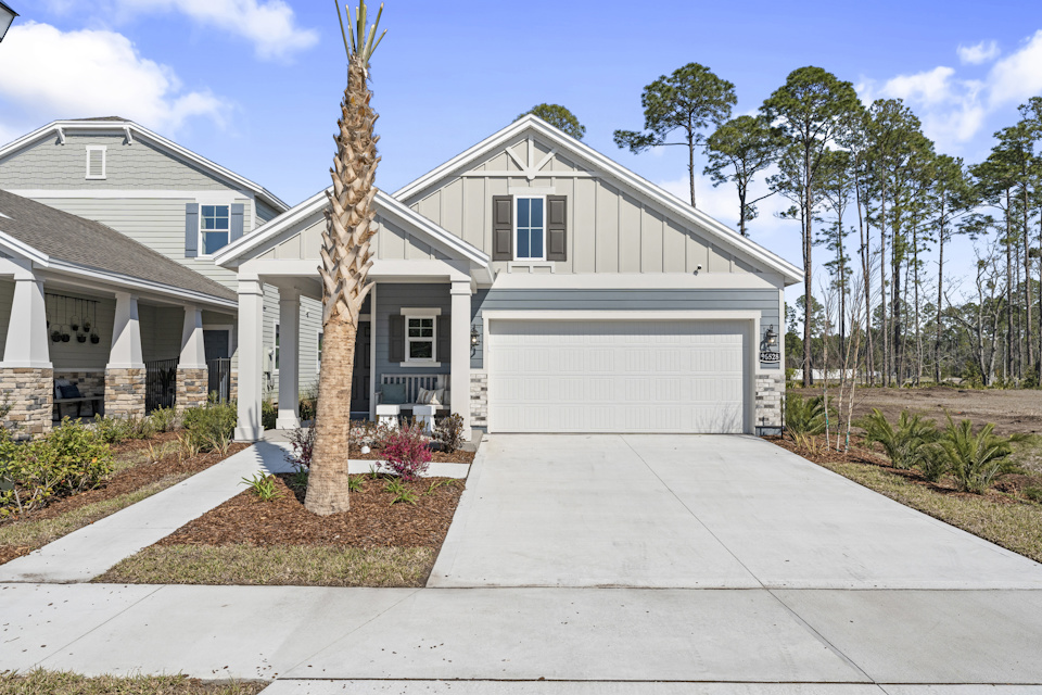 A white house with a garage.