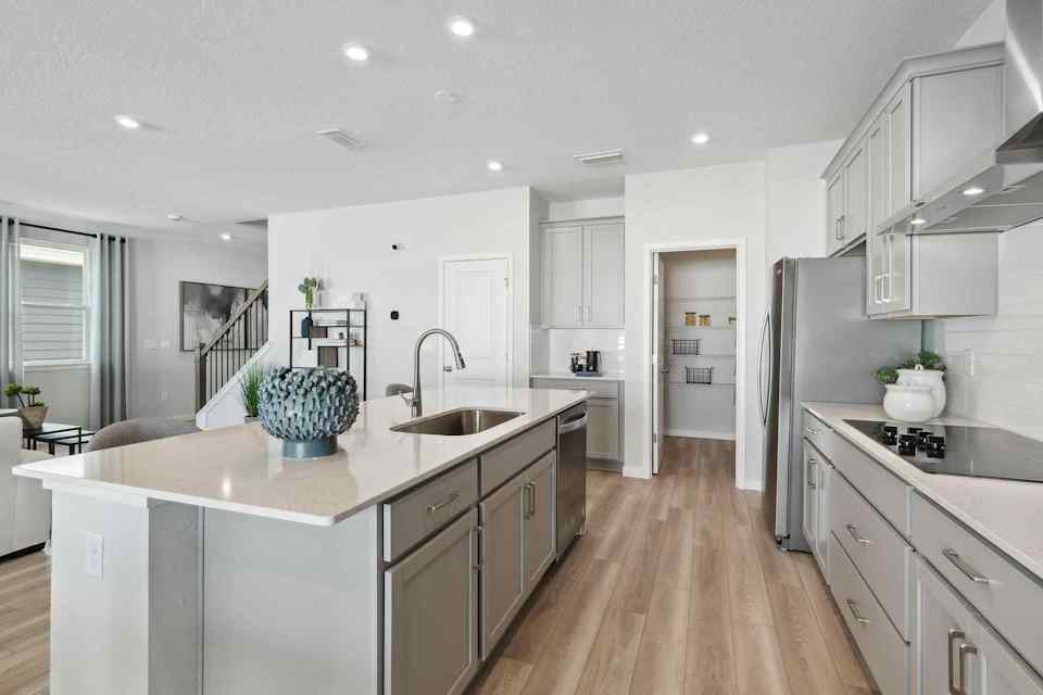 A kitchen with white cabinets.