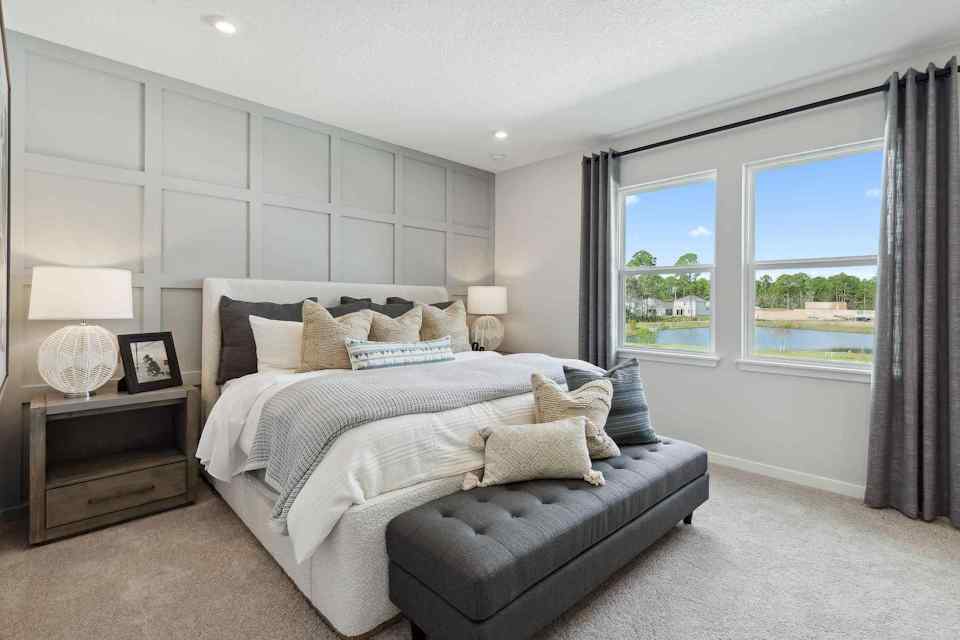 A bedroom with a large window.