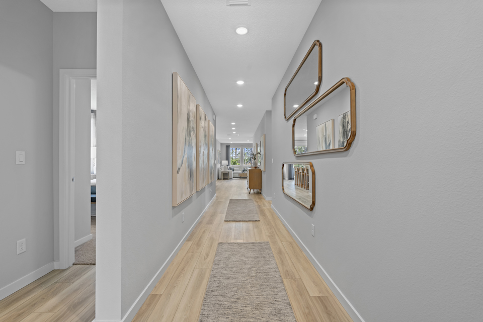 Coronado Model Home Entryway with a mirror and a rug at Reserve East in Flagler Beach