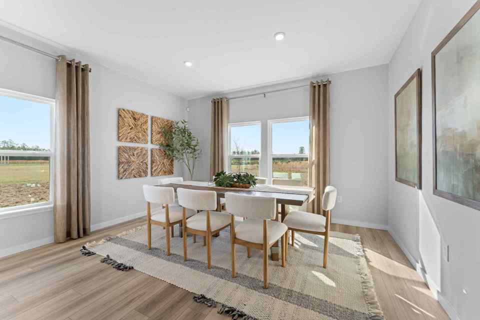 A dining room with a large window.