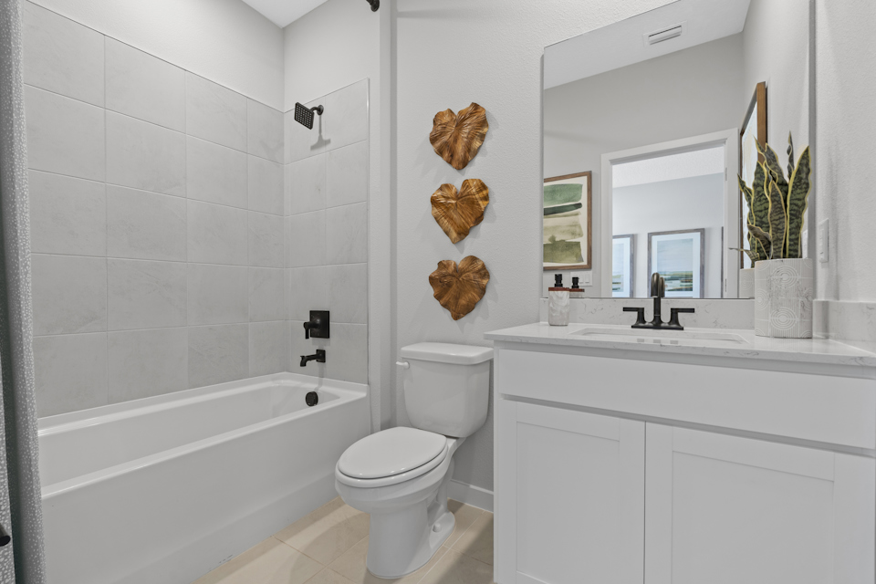 Kenai Model Home Guest Bath with Tub and Shower at Reserve East in Flagler Beach