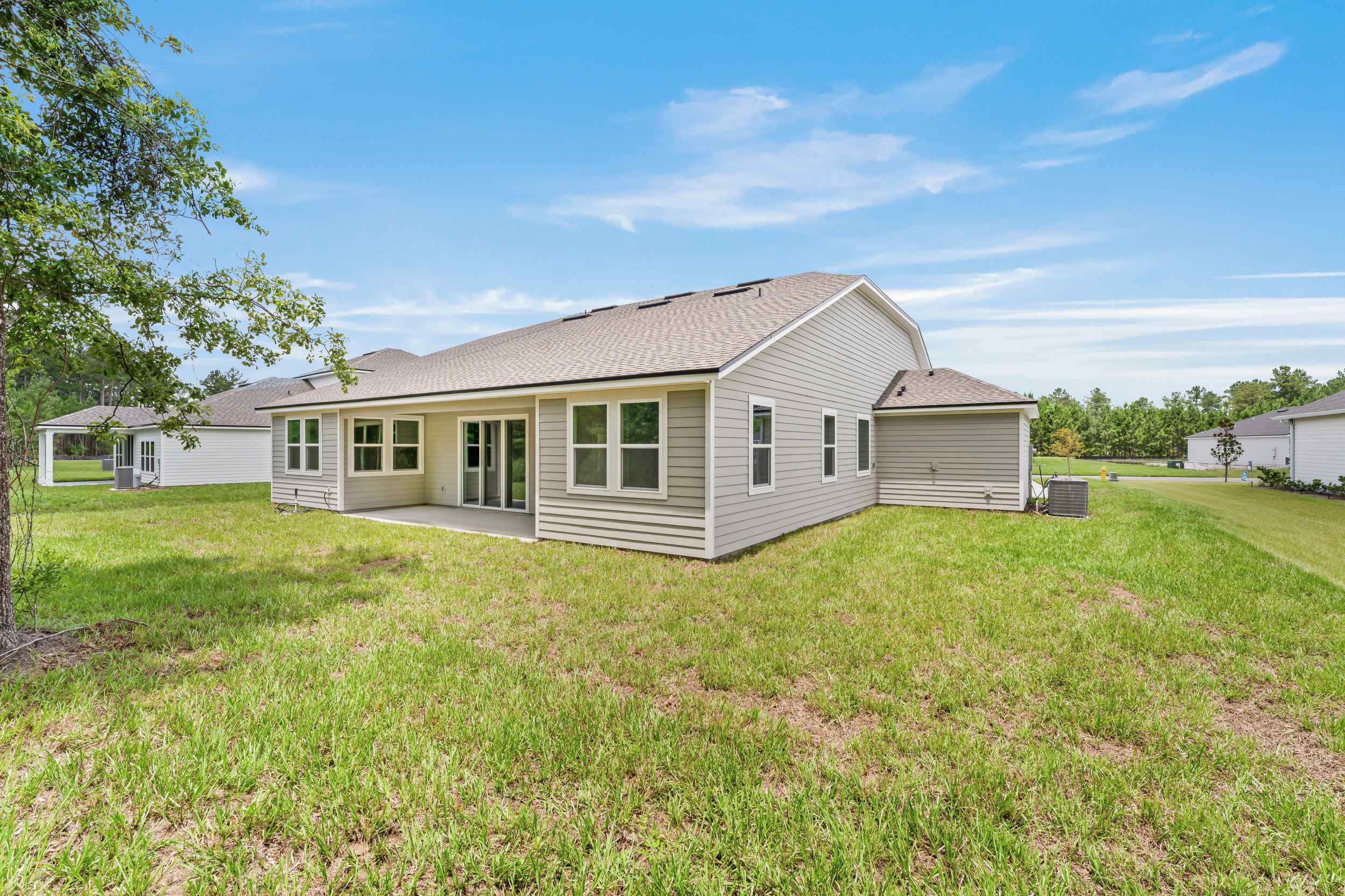 River Birch Lot 587 Rear Exterior with Covered Patio and 3-Bay Garage at NorthShore in Kingsland