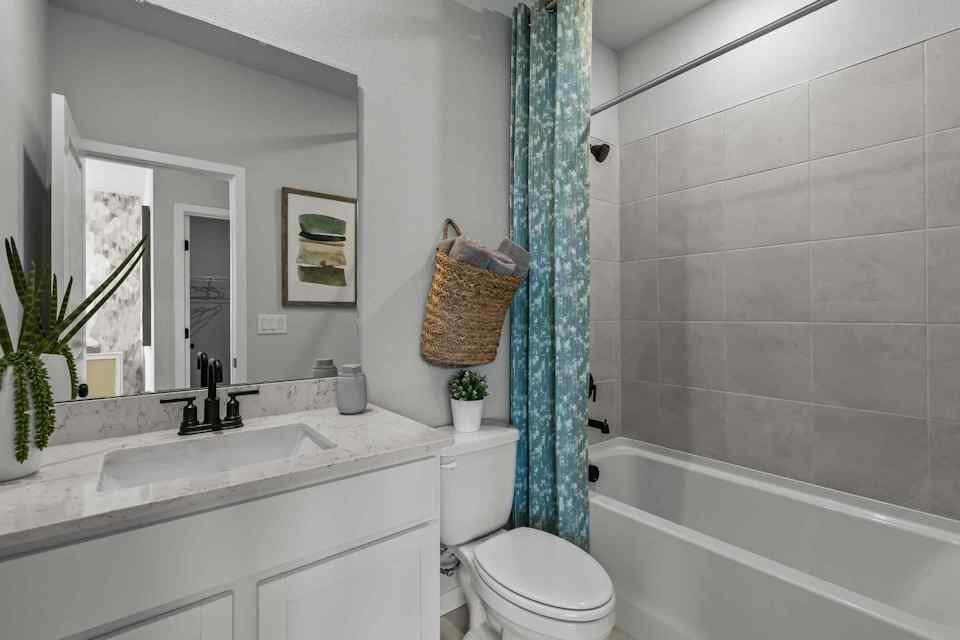 A bathroom with a tub toilet and sink.