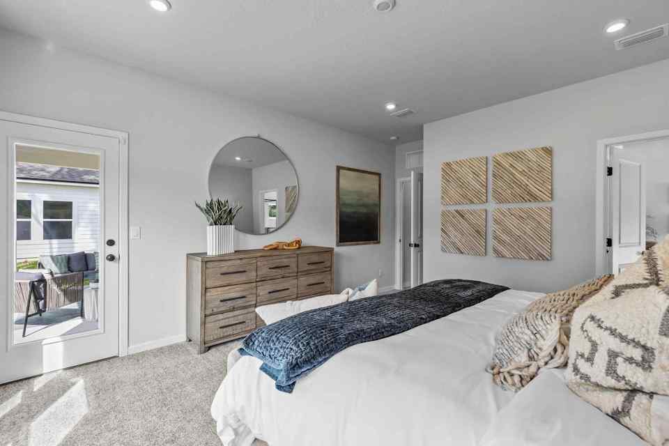 A bedroom with a bed and a dresser.