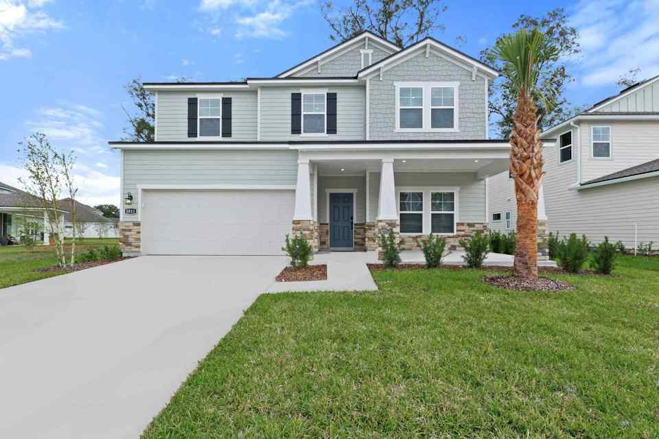 A white house with a driveway.