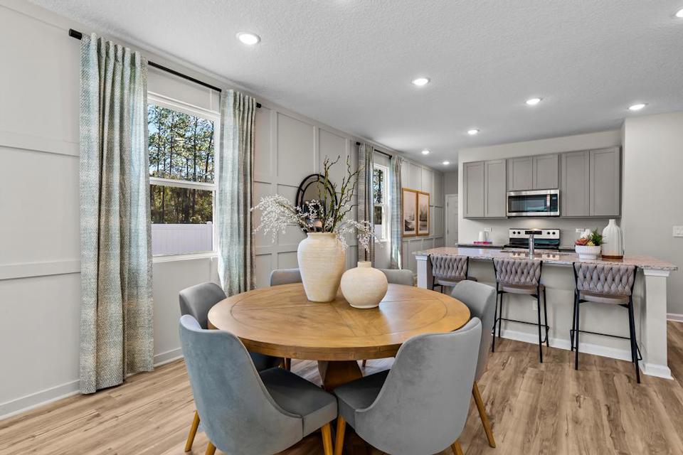 A kitchen with a dining table.