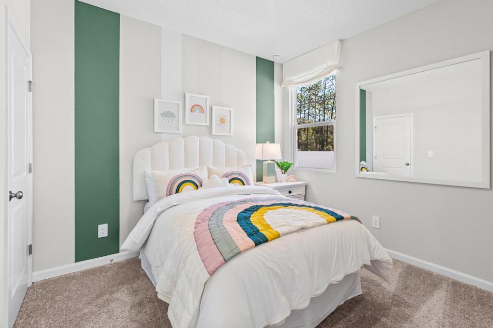 A bedroom with a bed and a window.