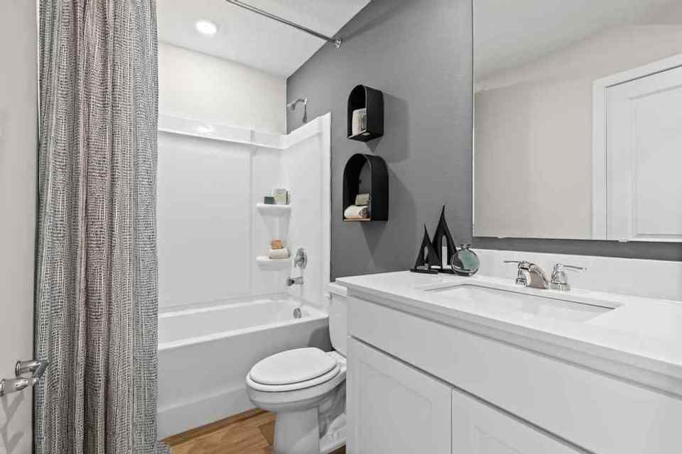 A bathroom with a tub sink and toilet.