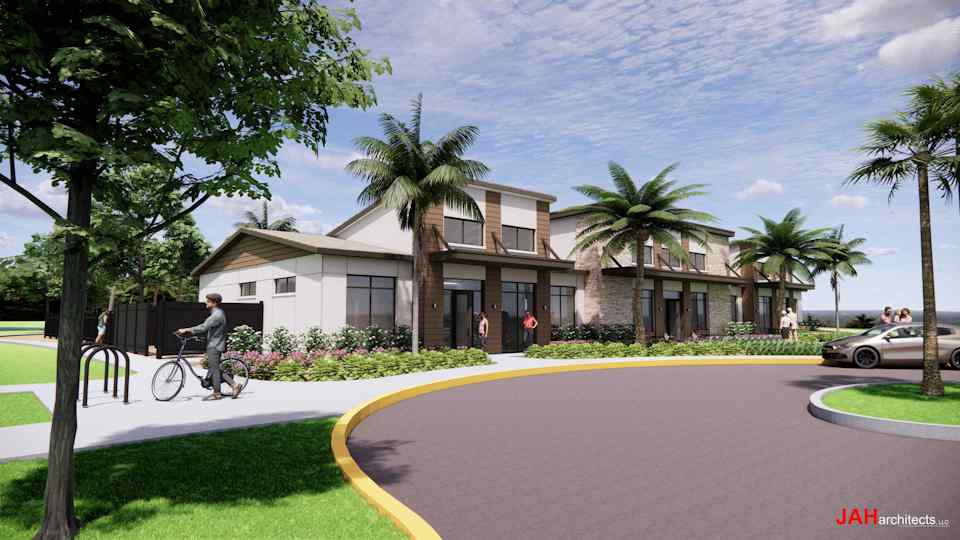 A person riding a bicycle on a street with palm trees and a building.