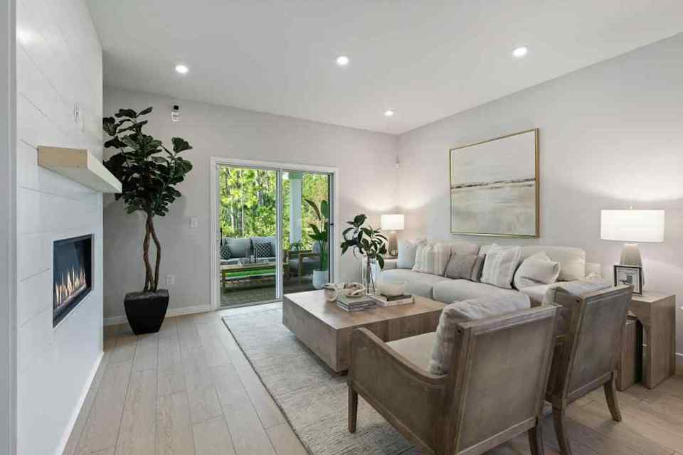 A living room with a couch and chairs.