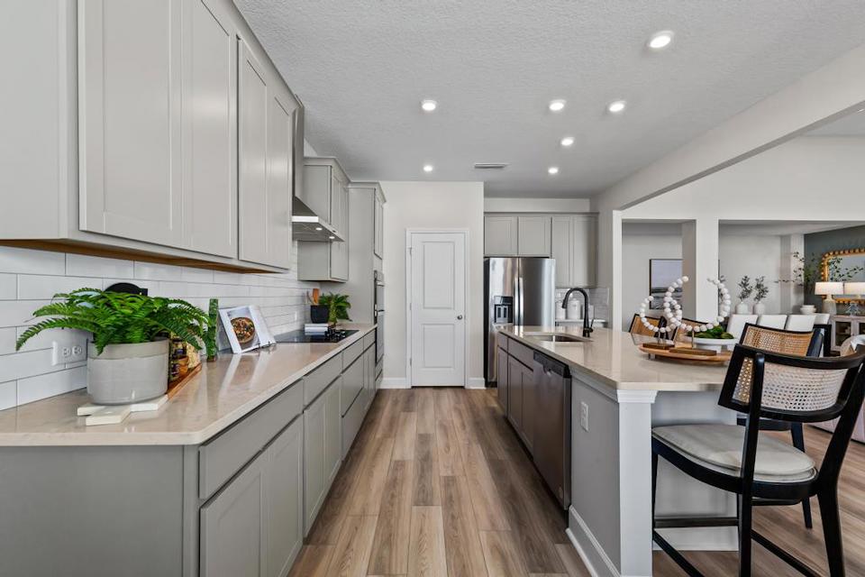A kitchen with white cabinets.