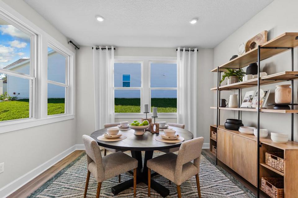 A dining room with a table and chairs.