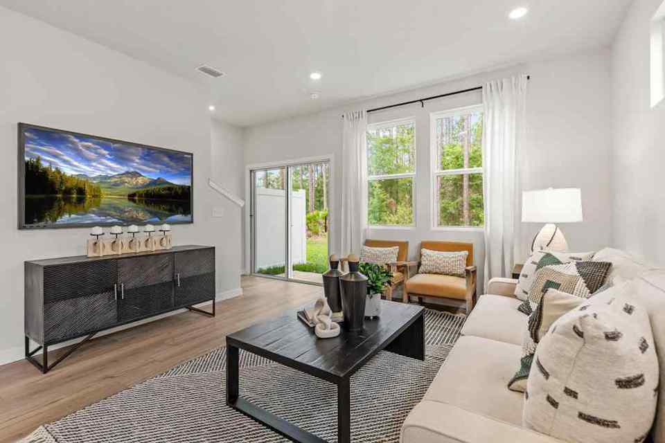 A living room with a large television.