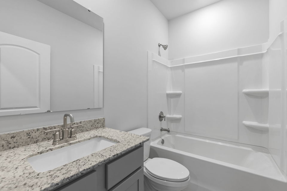 A bathroom with a marble countertop.