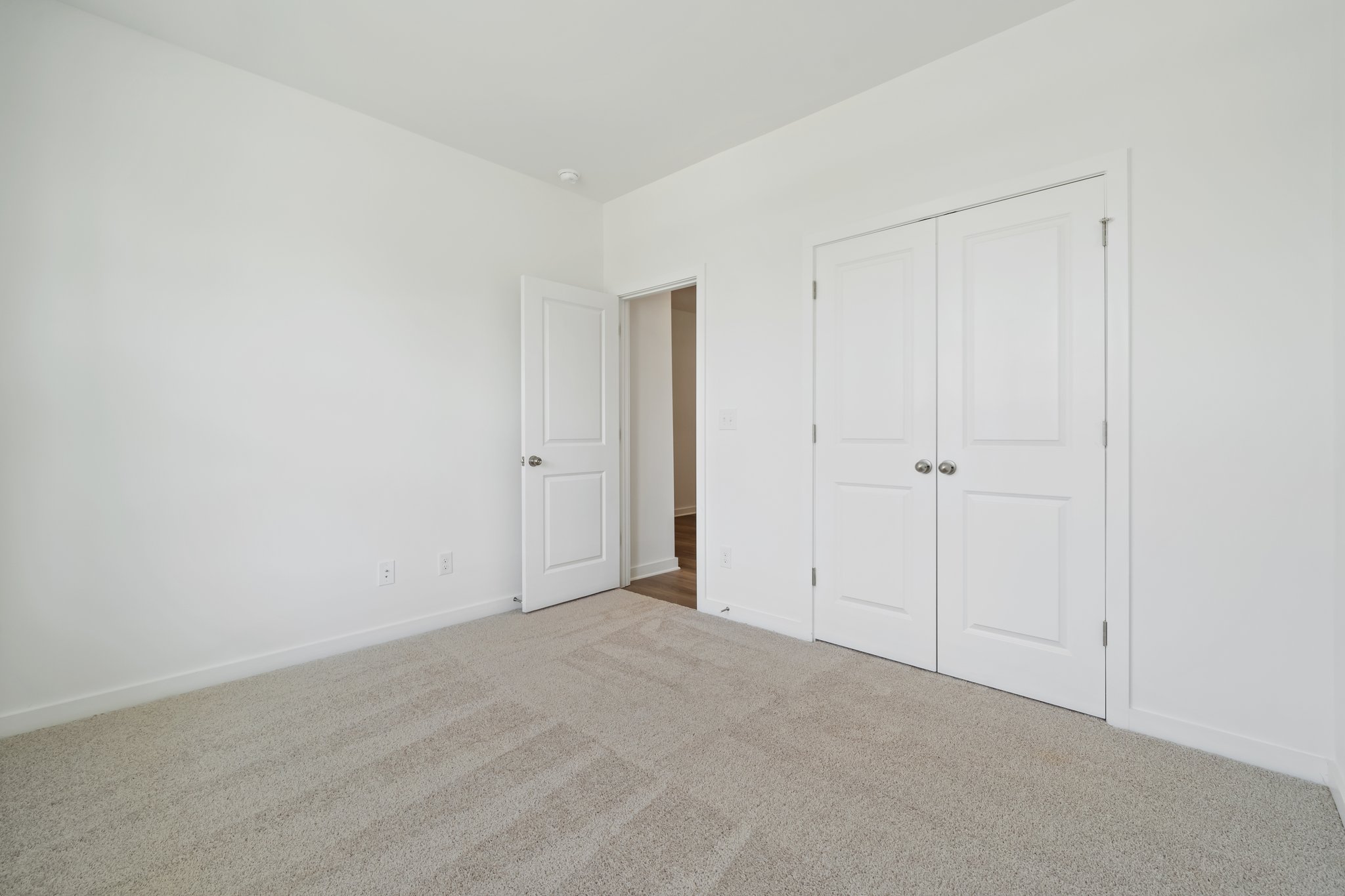 A hallway with white doors.
