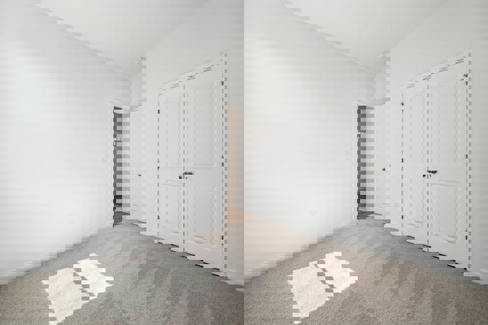 A hallway with white doors.