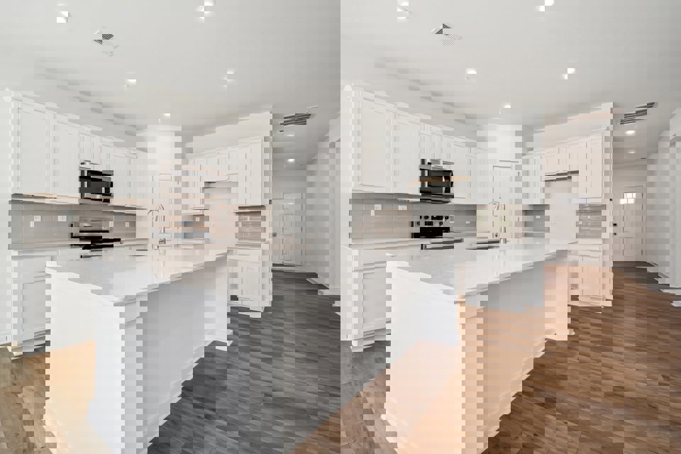 A kitchen with white cabinets.