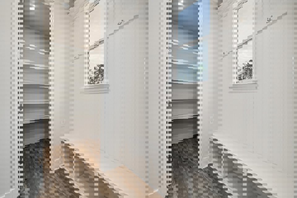 A white room with a window.