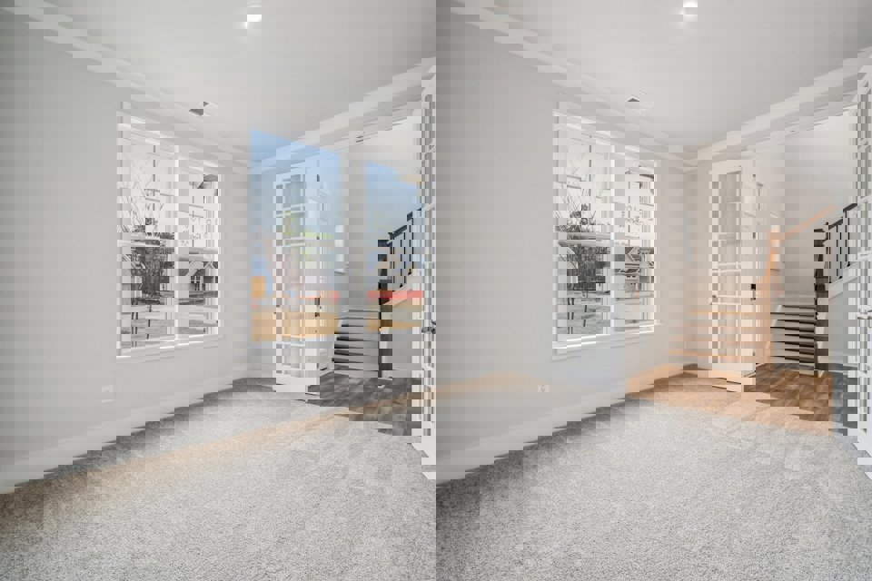 A room with a window and a staircase.