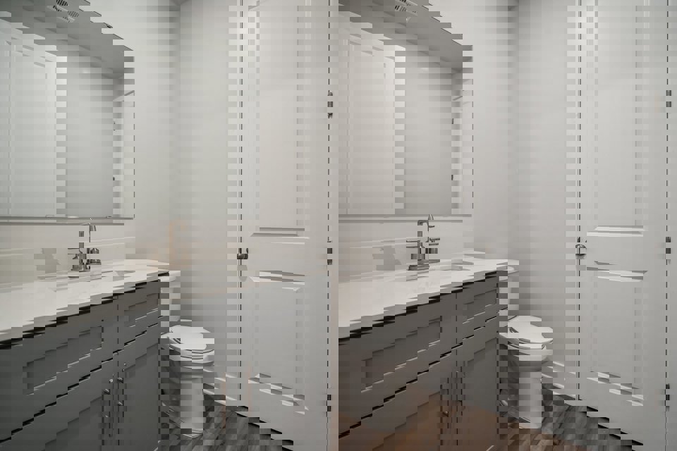 A bathroom with a toilet and sink.