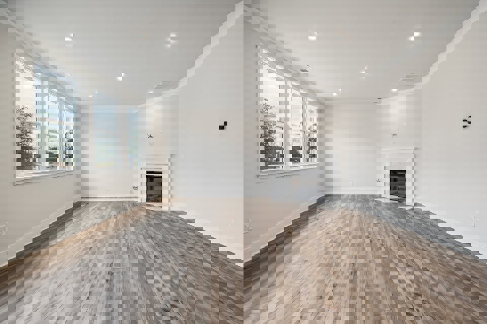 A room with a fireplace and a wood floor.