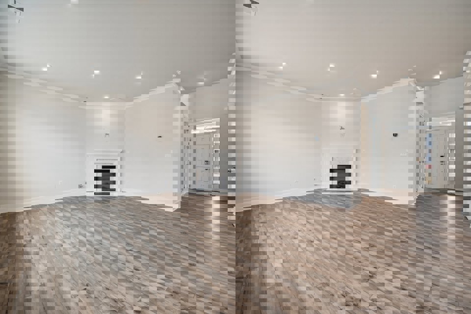 A large empty room with a fireplace.