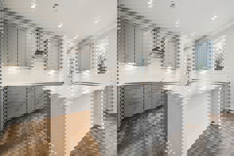 A kitchen with white cabinets.